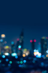 Vertical cover of blurred bokeh cityscape at twilight time, city background, aerial view angle from rooftop ob building, defocused city in downtown,graphic design for web online or book vertical cover