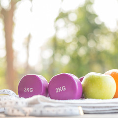 healthy lifestyle, food, sport or athlete's equipment on bright background. copy space. healthy eating, dieting, slimming and weigh loss concept - close up of green apple, measuring tape and fruit.