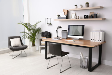 Modern computer on table in office interior. Stylish workplace - obrazy, fototapety, plakaty