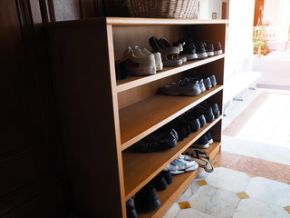 Fototapeta na wymiar Wooden shoe cabinet with shoes
