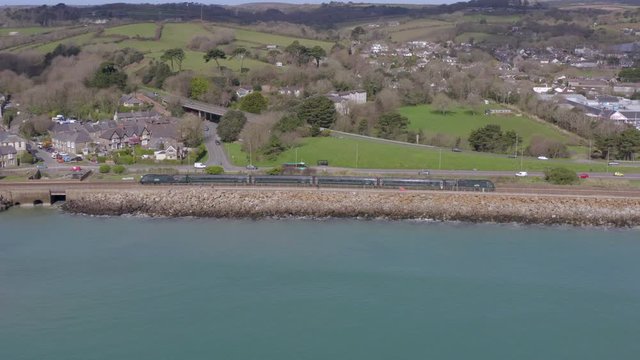 Commuter Train Travelling Slowly Alongside the Sea