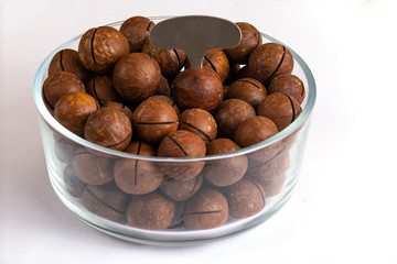 Australian macadamia nuts in a glass Cup on a white background