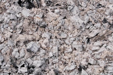 Abstract background texture of burnt ash. Coals in an extinct fire. Selective focus.