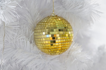 Golden Ball on White Christmas Tree