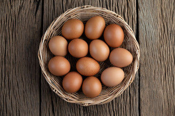 Lay eggs in a wooden basket on a wooden floor.