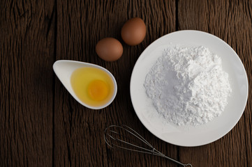 Eggs, tapioca flour and an egg beater, ingredients used in bakery