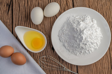 Eggs, tapioca flour and an egg beater, ingredients used in bakery