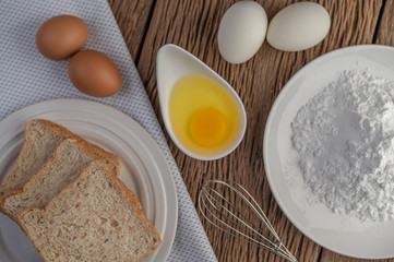 Eggs, bread, tapioca flour and an egg beater, ingredients used in bakery