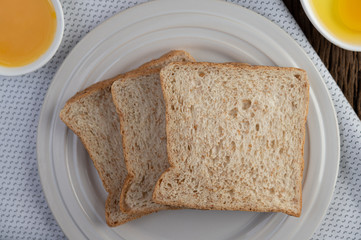 Eggs, bread, tapioca flour and an egg beater, ingredients used in bakery