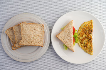 Omelette and sandwiches are in a color palette on a white background.