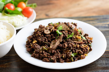 Northern Thai food, spicy minced pork salad (Larb Moo Kua) eating with sticky rice and fresh...