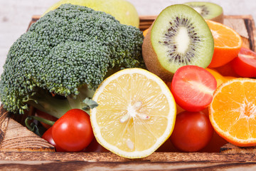 Natural fruits and vegetables in wooden box. Nutritious food containing minerals and vitamins