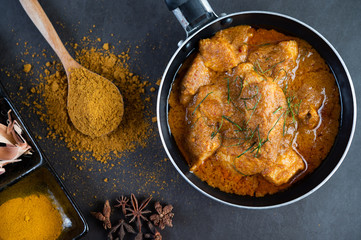 Massaman curry in a frying pan with spices on the cement floor - obrazy, fototapety, plakaty