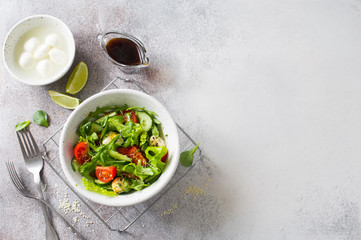 Fresh vegetable salad with lettuce, tomatoes, cucumbers and mozzarella