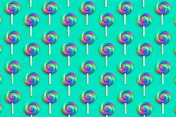 Lollipops are in a row. spiral candy pattern. lots of sweets on a turquoise background. festive decoration