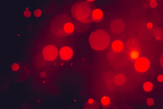 Dark Abstract Red bokeh sparkle on black background