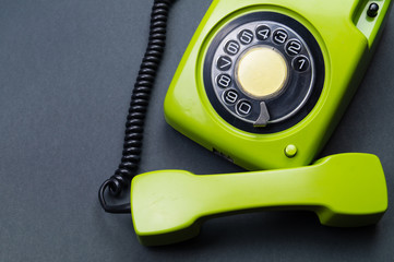 Classic phone with handset. vintage green telephone with phone receiver. office background. old communication technology