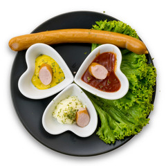 top view of saucages and sauces in heart shaped bowls