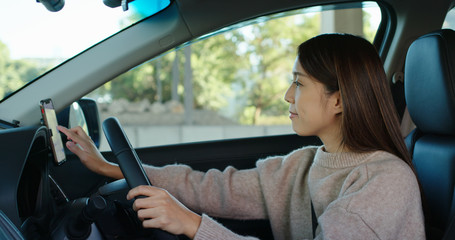 Woman set gps location on cellphone inside a car