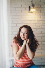 Woman by the window. Girl looking out. Concept oflife style, holidays