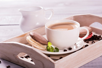 chocolate macaroon with a cup of coffee  on the wooden background