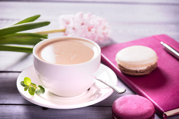 Fototapeta na wymiar Pink macaroon with pink hyacinth on the wooden background