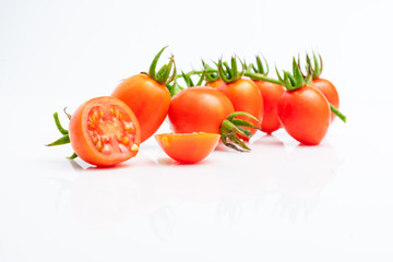 fresh red cherry tomatoes (grape tomatoes ) on white background.