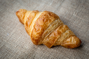 Tasty croissants clean brown sack background.