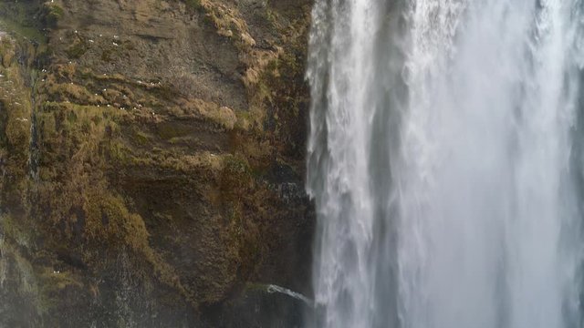 The edge of a waterfall next to the shear cliffs at Skogafoss in Iceland. Film location of Game of thrones.