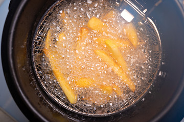 French fries. oil boiling in a deep fryer at home.
