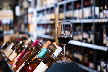 Closeup of red wine glass in wine shop