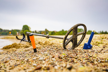 Metal detector with accessories on beach