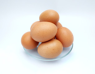 Eggs in a glass dish on white background.