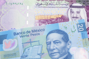 A twenty Mexican peso bill, shot in macro with a five Saudi riyal bank note from Saudi Arabia