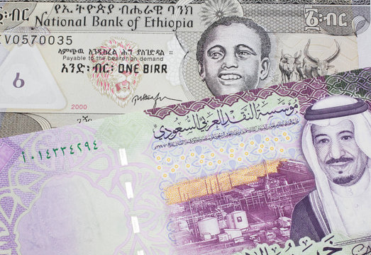 A one birr note from Ethiopia in macro with a five riyal Saudi Arabian bank note close up