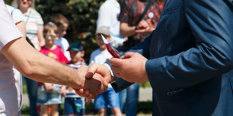 awarding handshake and congratulations in honor of the holiday