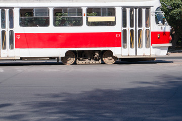 Fototapeta na wymiar old red tram in the city wheels close up