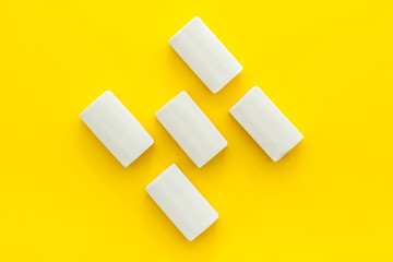 Soap bars flat lay on yellow background top-down pattern