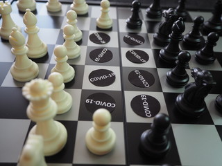 Chess pieces battling against  COVID-19 