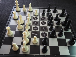Chess pieces battling against  COVID-19 