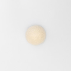 top view of cleaning pores and removes old skin smoothly natural konjac puff sponge for sensitive body skincare shower scrubbing on white background