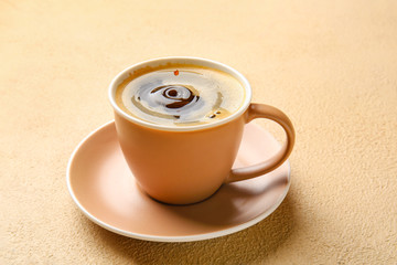 Cup of hot coffee on color background