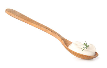 Spoon with tasty sour cream on white background