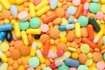 Fototapeta na wymiar Heap of different pills as background