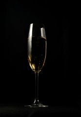 glass of white wine on black background