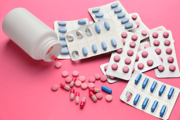 Different pills on color background