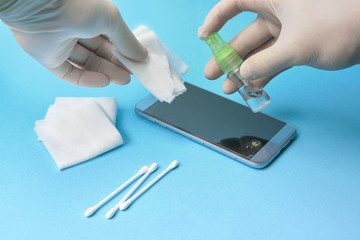 smartphone disinfection with rubber gloves.