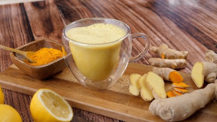 Immunity Boosting Antivirus Drink. Healthy Turmeric Latte Drink With Almond Milk In A Glass Cup. 