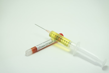 Coronavirus vaccine next to a tube of blood that indicates positive for this disease.  The 2019-NcOv affects many countries but especially in China, Italy and Spain.