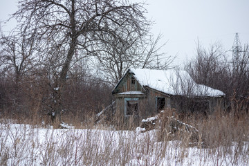 Old abandoned wooden house in winter